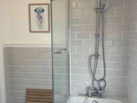 A bathroom with a shower and bathtub at 3 Newboro Terrace in Conwy