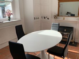 A dining room with a round table and four chairs at 3 Newboro Terrace in Conwy