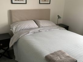 A bedroom with a bed and bedside table at 3 Newboro Terrace in Conwy