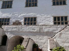 An outdoor area with windows and stone wall details at 3 Newboro Terrace, Conwy