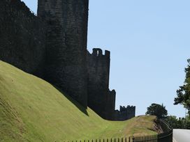 Castle wall with towers and grass area at 3 Newboro Terrace in Conwy