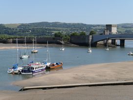 A view of boats near a bridge and fortification at 3 Newboro Terrace Conwy