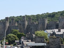 A castle with towers and trees at 3 Newboro Terrace in Conwy