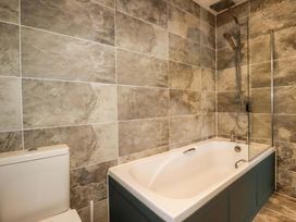 A bathroom with a bathtub and toilet at Meadow Retreat in Bodmin