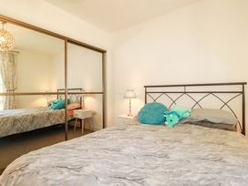 A bedroom with a bed and nightstand at Meadow Retreat in Bodmin