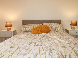 A bedroom with a bed and side tables at Meadow Retreat in Wadebridge