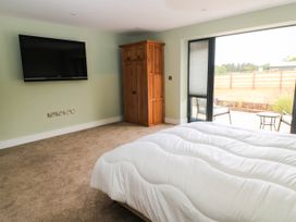 A bedroom with a bed and a wardrobe at Hazeldene near Harvington