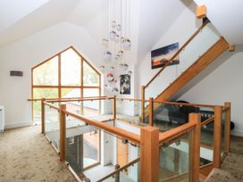 A hallway with a staircase and window at Hazeldene near Harvington