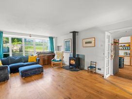 A living room with a sofa and stove at Chantry Studio in Kingsbridge