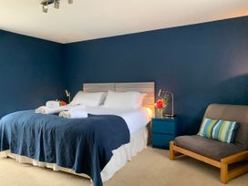 A bedroom with a bed and bedside table at Chantry Studio in Kingsbridge