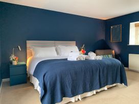 A bedroom with a bed and nightstand at Chantry Studio in Kingsbridge