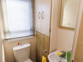 A bathroom with a toilet and sink at Sunflower Retreat, Caravan 61