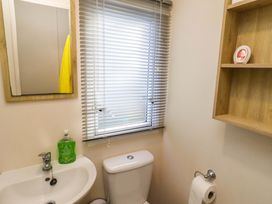 A bathroom with a sink and toilet at Sunflower Retreat, Caravan 61