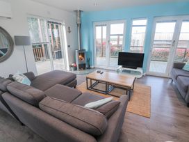 A living room with a fireplace and television at Warleggan in Redruth