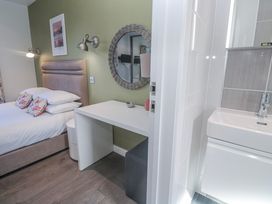 A bedroom with a bed and a desk at Warleggan in Redruth