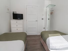A bedroom with two beds and a television at Warleggan in Redruth