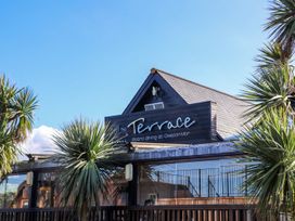 The exterior of The Terrace with palm trees at Gwelan Mor in Portreath