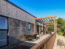 An outdoor area with a deck, table and chairs at Warleggan, Portreath