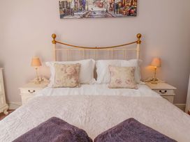 A bedroom with a bed and bedside lamps at Annie's Place in Sleights