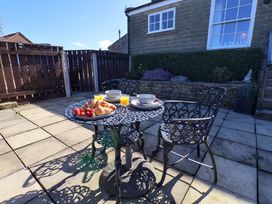 An outdoor patio with a table set for breakfast at Annie's Place in Sleights
