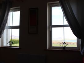 Windows with decorative plants and curtains at Welcome to the wild Atlantic way Mulroy Bay