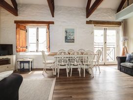 A living room with a dining table and chairs at Daniel’s Sail Loft Penthouse in Penryn