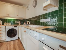 A kitchen with appliances and countertops at Daniel’s Sail Loft Penthouse in Penryn