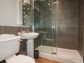 A bathroom with a toilet, sink, and shower at Daniel’s Sail Loft Penthouse in Penryn