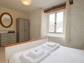 A bedroom with a bed and furniture at Daniel’s Sail Loft Penthouse in Penryn