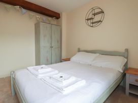A bedroom with a bed and wardrobe at Daniel’s Sail Loft Penthouse in Penryn