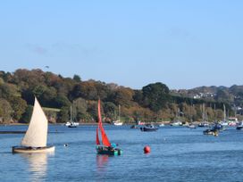 Sailboats on a river with trees in the background at Daniel’s Sail Loft Penthouse, Penryn