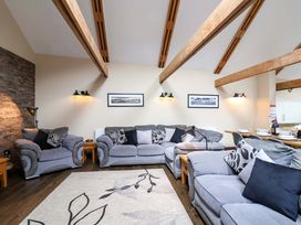 A living room with sofas and a coffee table at Cider Press Cottage in Torpoint
