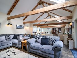 A living room with a sofa and coffee table at Cider Press Cottage in Torpoint