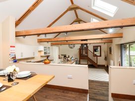 A kitchen with a dining table and counter at Cider Press Cottage Torpoint