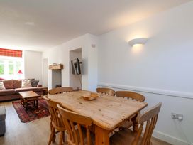 A dining room with a table and chairs at Cozy Cottage
