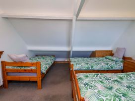A bedroom with two beds and a bedside table at Cozy Cottage