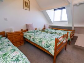 A bedroom with two beds and a window at Cozy Cottage