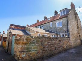 A brick and stone building with a pathway at Cozy Cottage 