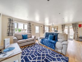 A living room with sofas and a table at Lodge 4 Near Brigg