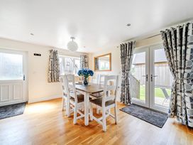 A dining room with a table and chairs at Lodge 4 Near Brigg