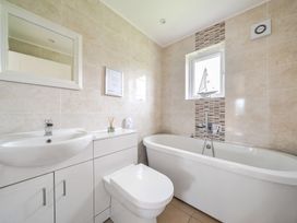 A bathroom with a bathtub and sink at Lodge 4 Near Brigg