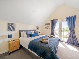 A bedroom with a bed and bedside table at Lodge 4 Near Brigg