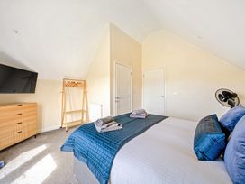 A bedroom with a bed and television at Lodge 4 Near Brigg