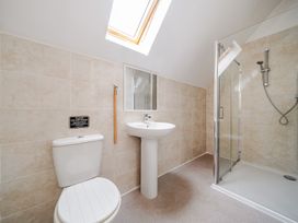 A bathroom with a shower and wash basin at Lodge 4 Near Brigg