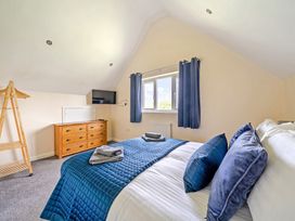 A bedroom with a bed and dresser at Lodge 4 Near Brigg