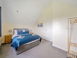 A bedroom with a bed and nightstand at Lodge 4 near Brigg