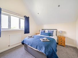 A bedroom with a bed and windows at Lodge 4 Near Brigg
