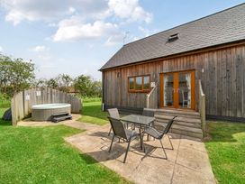 An outdoor area with a hot tub and a seating arrangement at Lodge 4 Near Brigg