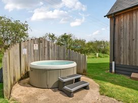 An outdoor area with a hot tub and stool at Lodge 4 Near Brigg
