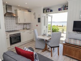 A kitchen with a table and chairs at The Bolthole in Newport